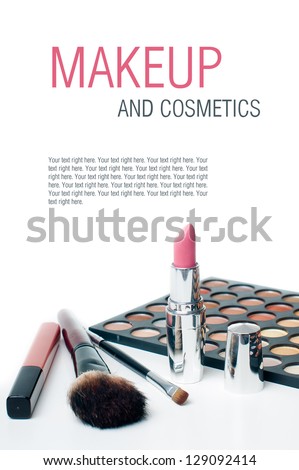 Palette of colorful eyeshadows, lipstick and makeup brushes, close-up, isolated