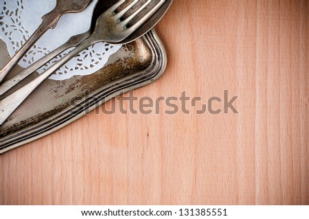 Vintage cutlery tray and old wooden board, close-up, food background