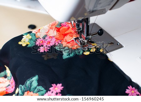 Machine sewing: a close-up sewing machine, needle, thread and silk fabric, close-up