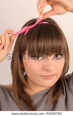 Young pretty girl, tied her hair with a ribbon