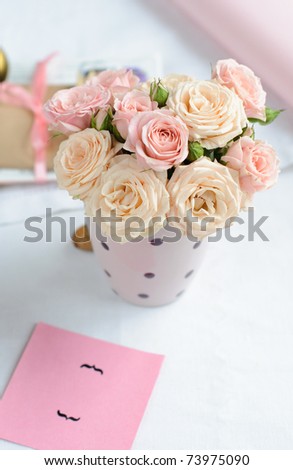 bouquet of delicate pink roses in a cup on the table