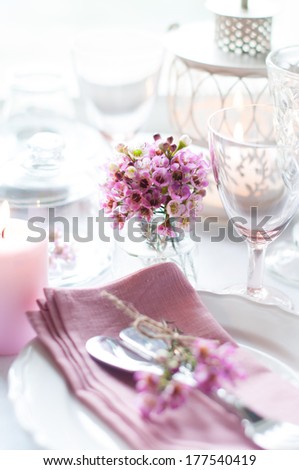 Bouquet of pink flowers on a festively decorated table, a bright summer table decor.