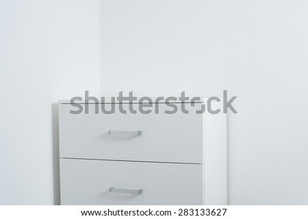 Empty white wall and a chest of drawers, modern home interior decor template with copy space