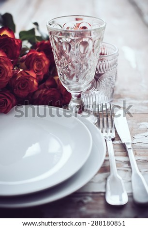 Vintage table setting with glasses and cutlery on an old wooden board, wedding table decor