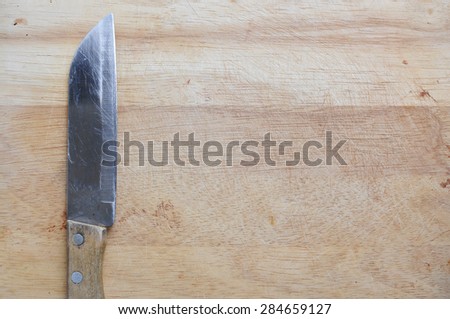 Wood cutting board with a knife