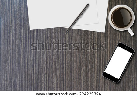 Smartphone, coffee cup, pen and page on wood background with copy space and text space