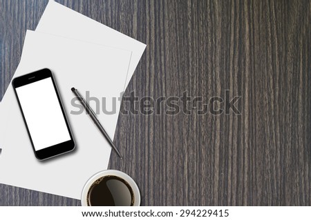 Smartphone, coffee cup, pen and page on wood background with copy space and text space