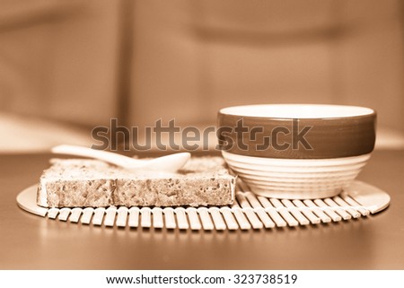 Blur background of bread and cup coffee on the table, Bread and a cup of coffee on a table, The mood vintage background.