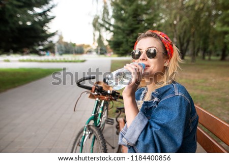 Similar – Image, Stock Photo Positive female cyclist resting on street