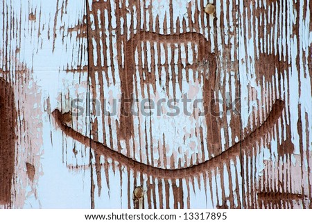 Horizontal image of a western cowboy hat branded into an old barn door.