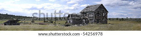 Panoramic view of back of 19th century homestead house with horse barn and windmill.  Measures 55.296\