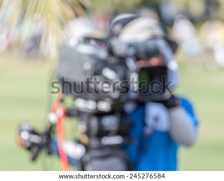Blurred background of sport photographer is working during golf tournament in golf course for live broadcasting.