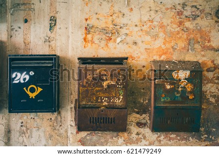 Similar – Image, Stock Photo old, pasted mailbox slot with a flap that says “LETTERS”, made of metal in an old wooden door, where the brown paint is peeling off / write letter / e-mail / mailbox company