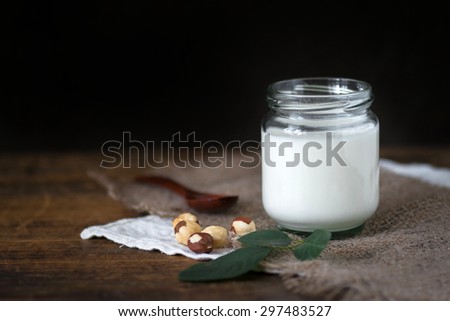 Homemade greek yogurt in jar on wooden table, rustic still life