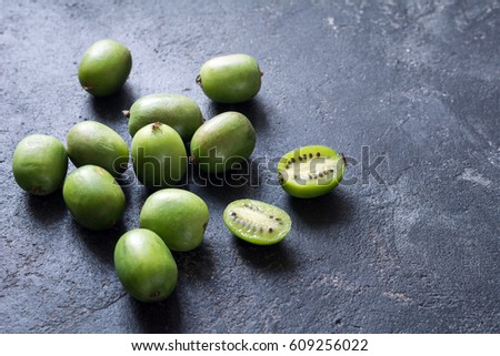 Baby kiwi or mini kiwi fruits on stone background. Closeup view Photo stock © 