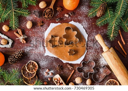 Similar – Image, Stock Photo Gingerbread cookies dough cut in different shapes on a blue table. Baking Christmas cookies