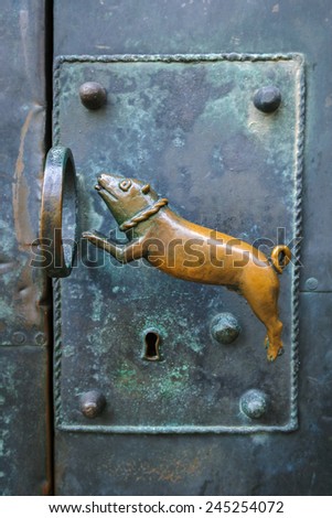 Door handle in the form of a dog jumping through a ring in the castle of Quedlinburg, Germany