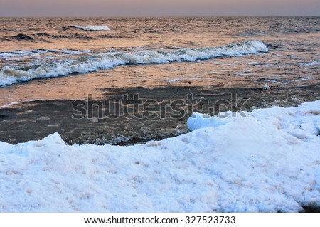 Snow, water and sky. Winter twilight sea view.
