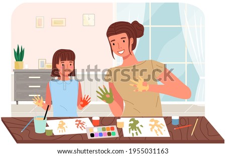 People paint hands with dye and leaves traces of palms on paper. Mother and daughter painting
