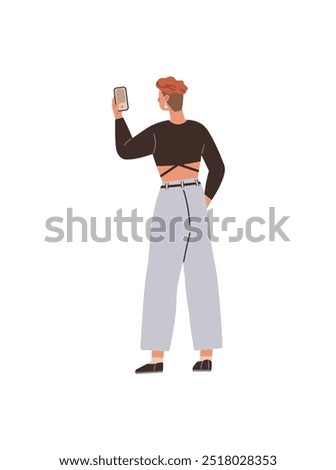 A young individual with short hair is seen taking a selfie with a smartphone, dressed in a crop top and wide-leg pants. Ideal for youth culture, social media, fashion, modern tech, casual style