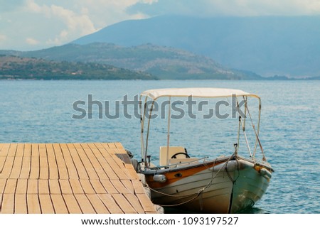 Motor boats drifting in the deep blue sea coast at pier.Sea background.Crystal clear water,good sunny weather.Beautiful blue lagoon for summer vacation trip