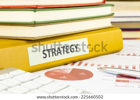Binder of business strategy documents with graph analysis and budget plan