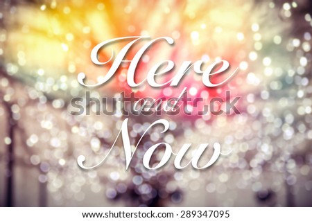 Here and Now typographic word on  abstract and glitter bokeh lights background, vintage and retro style image