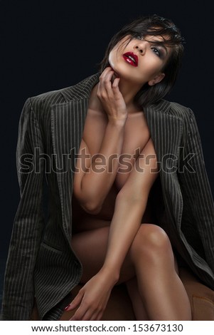 Stylish young woman in a jacket, clothed the naked body.