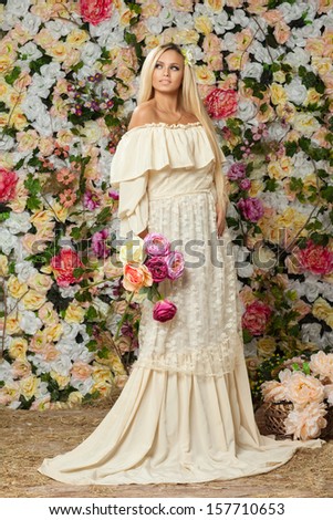 young girl in a spring garden of roses.