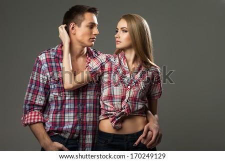 young couple, man and woman in stylish plaid shirt