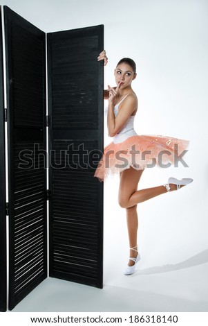 beautiful ballerina hiding behind the screen