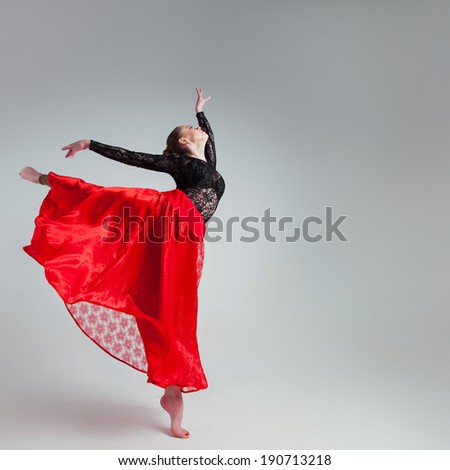 beautiful woman in a scenic suit dancing solo