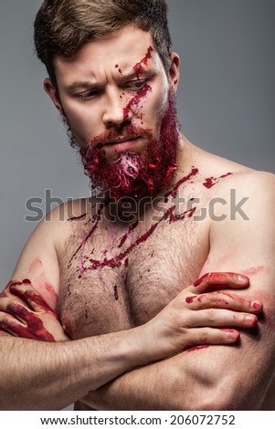 portrait of a bearded man smeared in paint