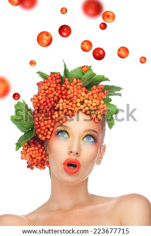 beautiful girl with berries viburnum on the head, and falling berries in autumn garden