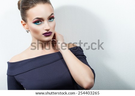 bright, passionate, aggressive woman with make-up on a white background