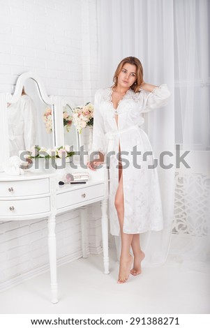and a beautiful young woman admiring a front of a mirror and looks after itself