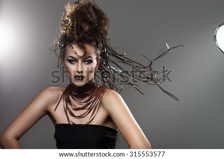 portrait of a beautiful woman with small ribbons in her hair