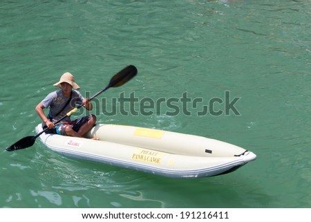 Room Island, Thailand - MARCH 28: unidentified  professional kayak man waits for pick up customer for get in on March 28,2014