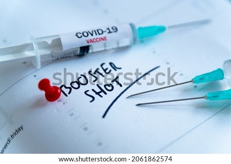 Third covid vaccine dose and jab concept. Three syringes are seen on calendar as a concept for the 3rd covid-19 vaccine dose, also called booster shot, now requested during the vaccination campaign.