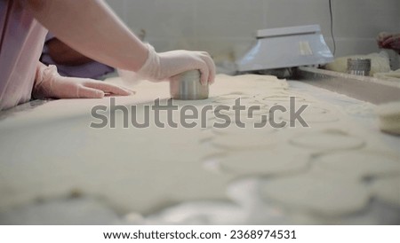 Similar – Image, Stock Photo Cook cutting dough with knife in shape on table