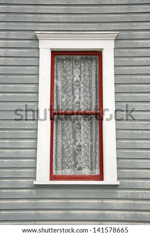 Old wooden window with vintage lace curtains