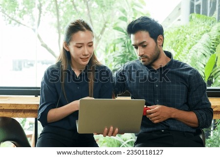 Portrait, company employee who is couple working in their favorite cafe, often come sit drink coffee on regular basis after work in evening, woman is explaining job that is not yet correct young man. ストックフォト © 