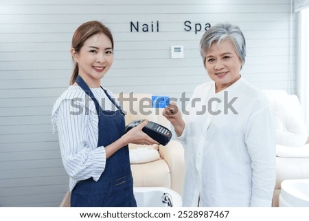 Similar – Image, Stock Photo Focused female cashier in face mask working with cash till