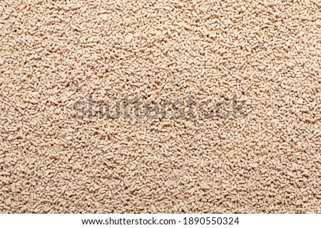 Background, texture from dry granular yeast, top view. Active dry yeast, top view. Heap of dry yeast granules, texture. Dry yeast is used in baked goods. Photo stock © 
