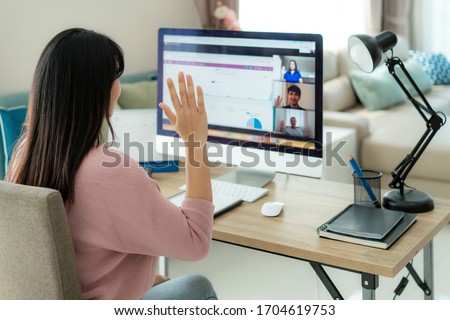 Asian business woman say hello or goodbye to her colleagues about plan in video conference. Multiethnic business team using computer for a online meeting in video call. 
