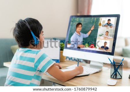 Asian boy student video conference e-learning with teacher and classmates on computer in living room at home. Homeschooling and distance learning ,online ,education and internet. Stock foto © 