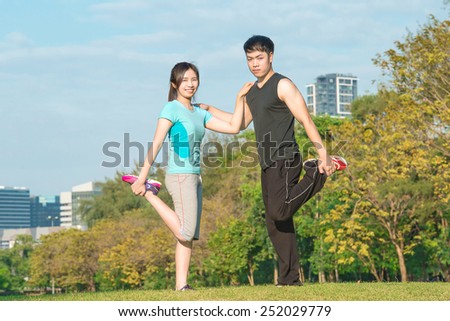 fitness, sport, training and lifestyle concept - Asian couple stretching outdoors