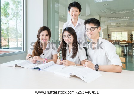 Group of asian students in uniform studying together at classroom