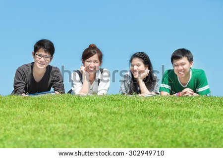 Group of friends studying outdoors at the park