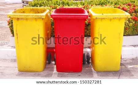red and yellow recycle bins in the park